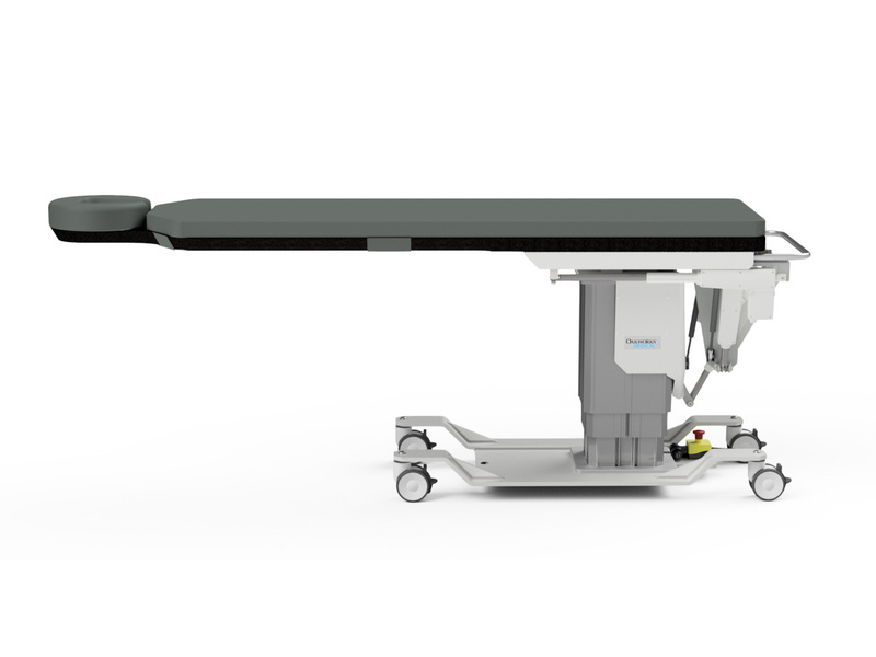 The CFPM400 table from the side: carbon fibre table top with integrated headrest, wide lifting column and lockable castor base